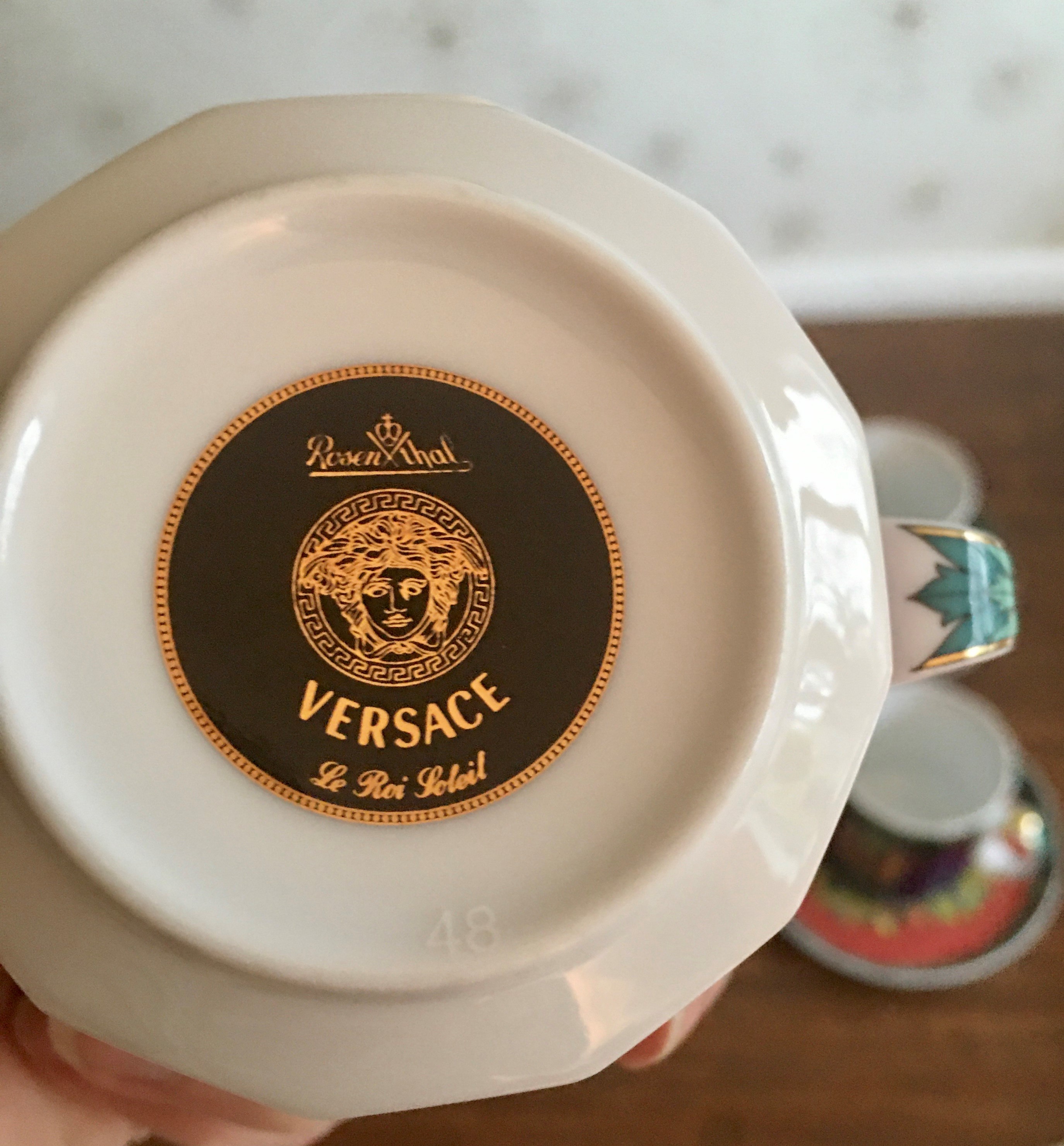 A set of eight Versace 'Le Roi Soleil' pattern cups and saucers